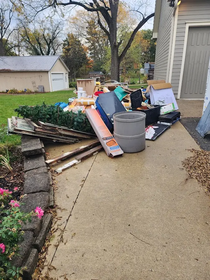 Dumpster being loaded with debris for Estate Cleanout Dumpster Rental in Grafton